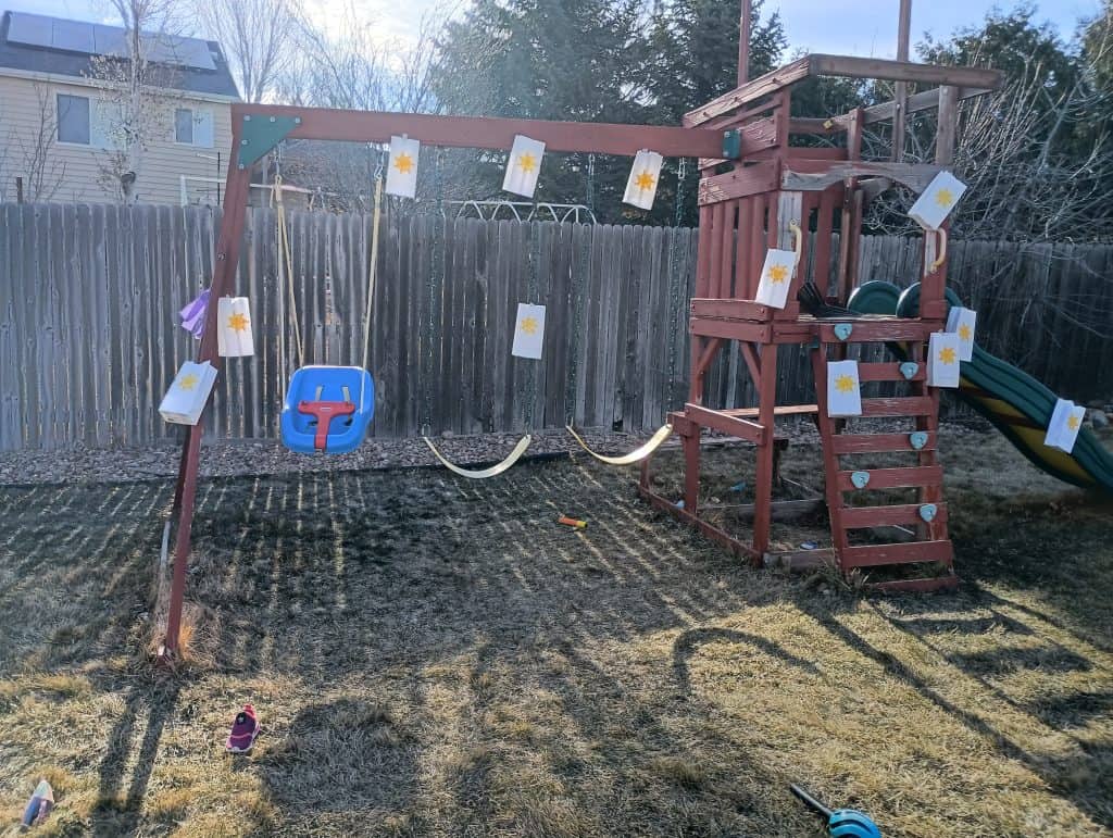 Picture of Rapunzel themed paper bags taped all over a swing set