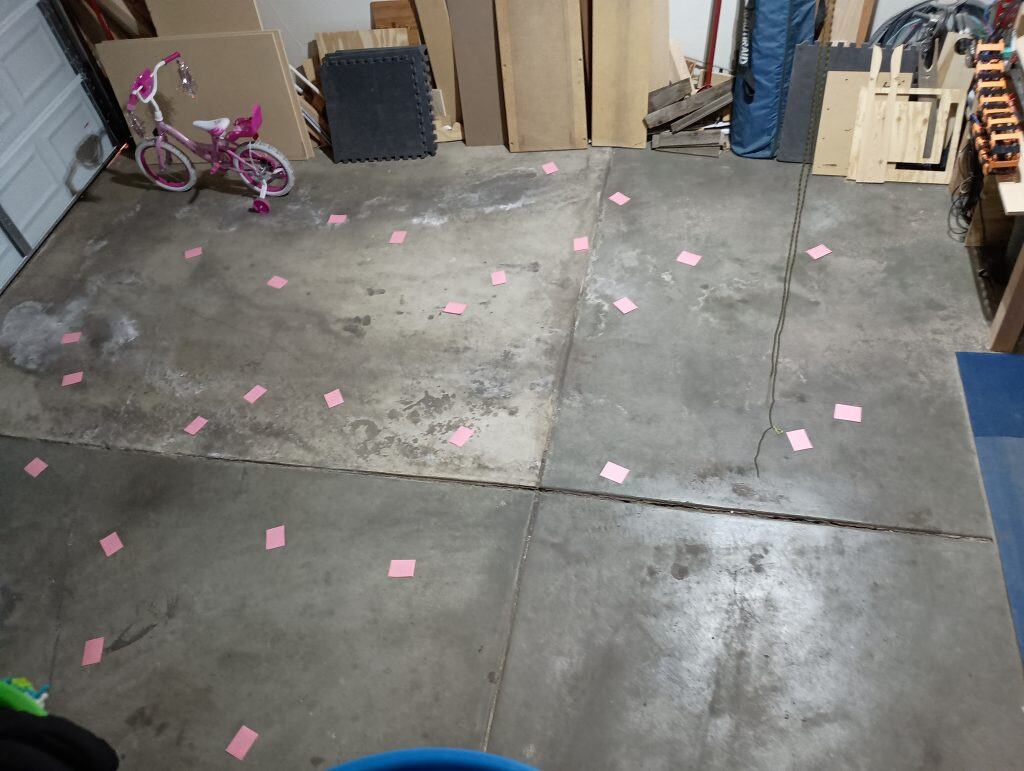 Picture of pink papers spread all over a garage floor