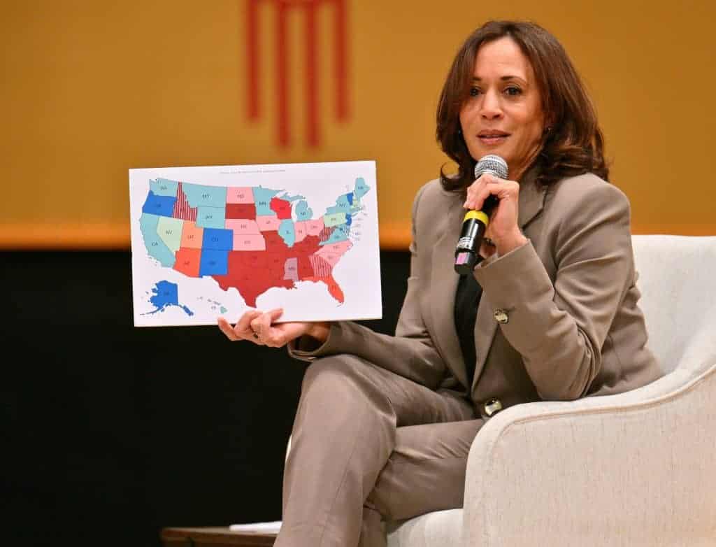Kamala Harris holding up a poster with a US States map made with MapChart