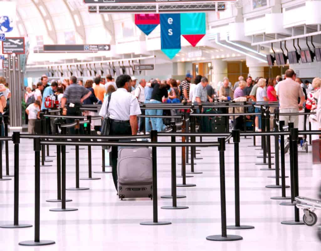 People lining up in the cables placed at the check in counters. Lisbon Airport security wait times can really take a long time.