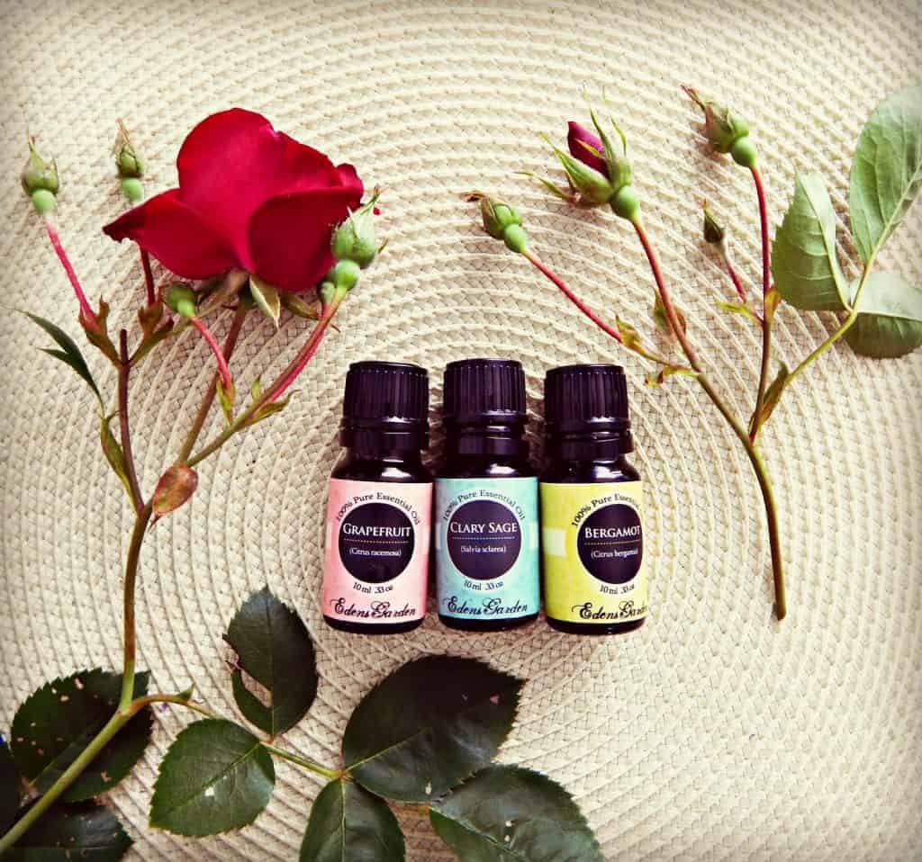 essential oil bottles on place mat surrounded by roses