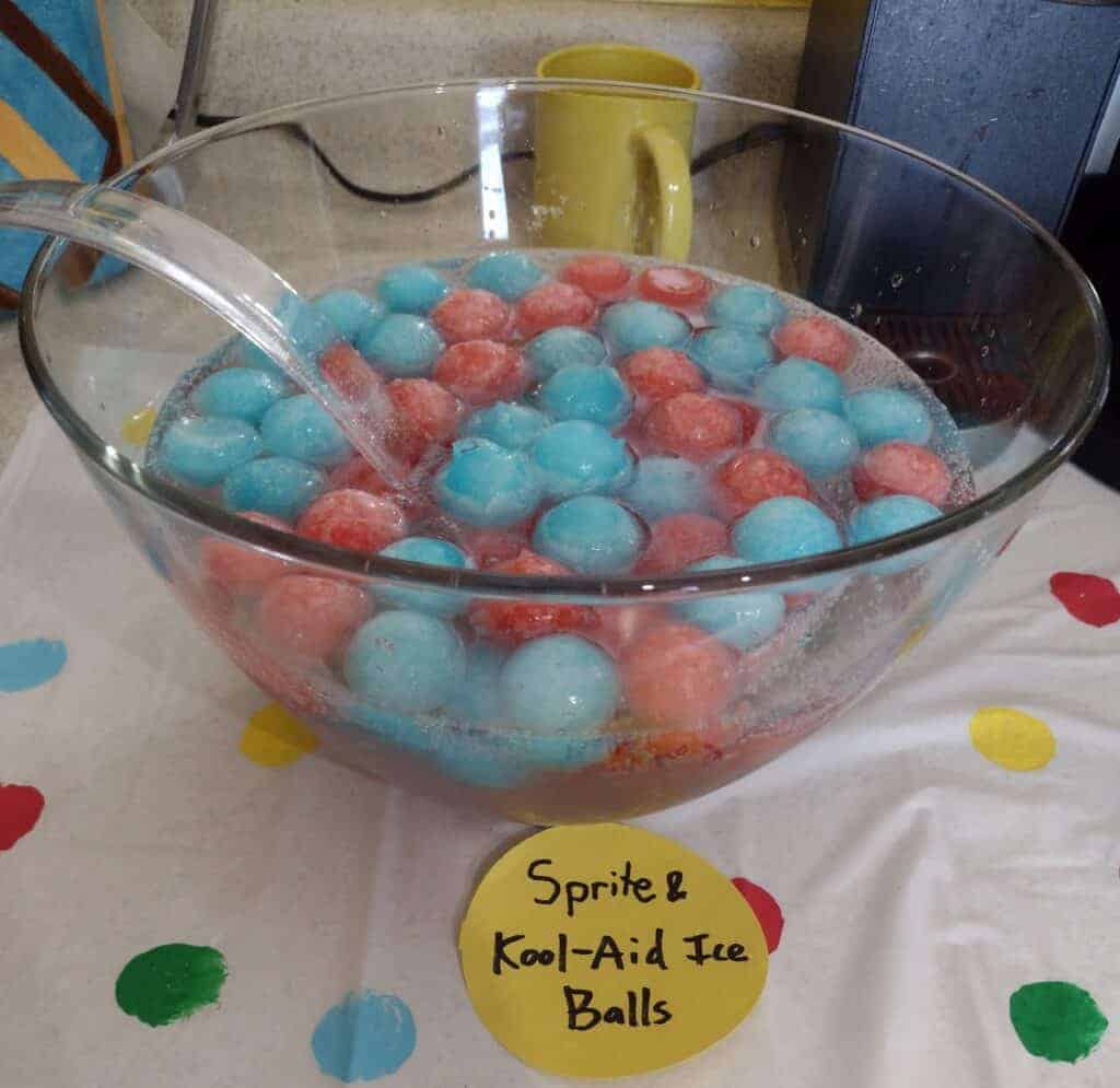 Picture of a punch bowl filled with Sprite and blue and red ball ice cubes made from Kool-Aid