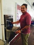 Refillable water bottle José Cerna NMSU closeup using reusable bottle at elkay water fountain. To go green in college
