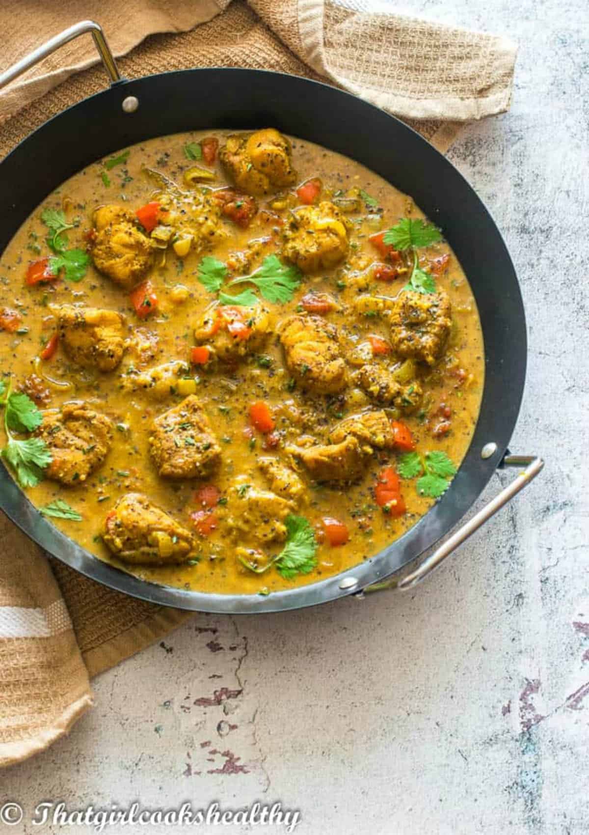 cod curried in a black skillet