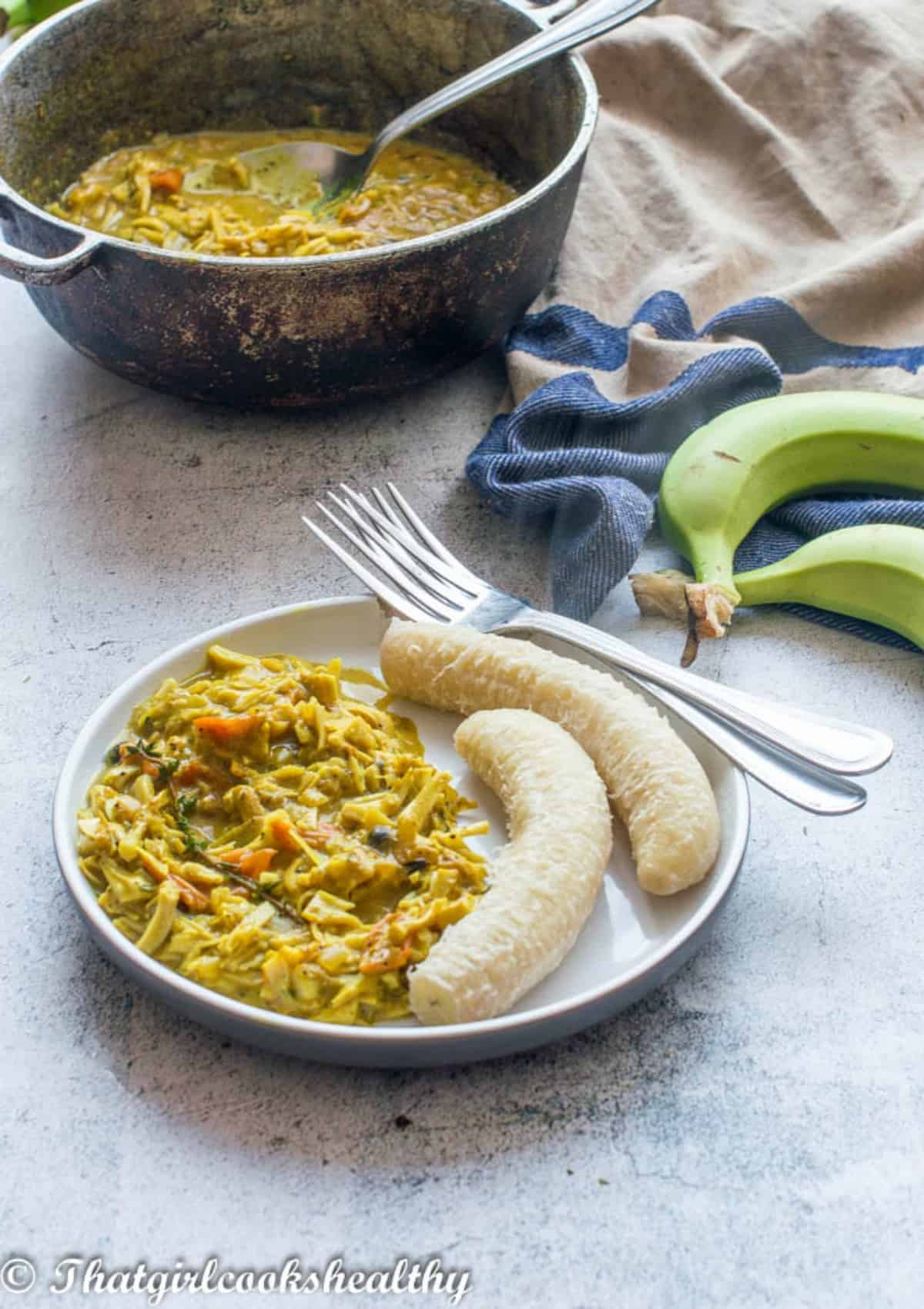 plate of food with dutch pot in the background