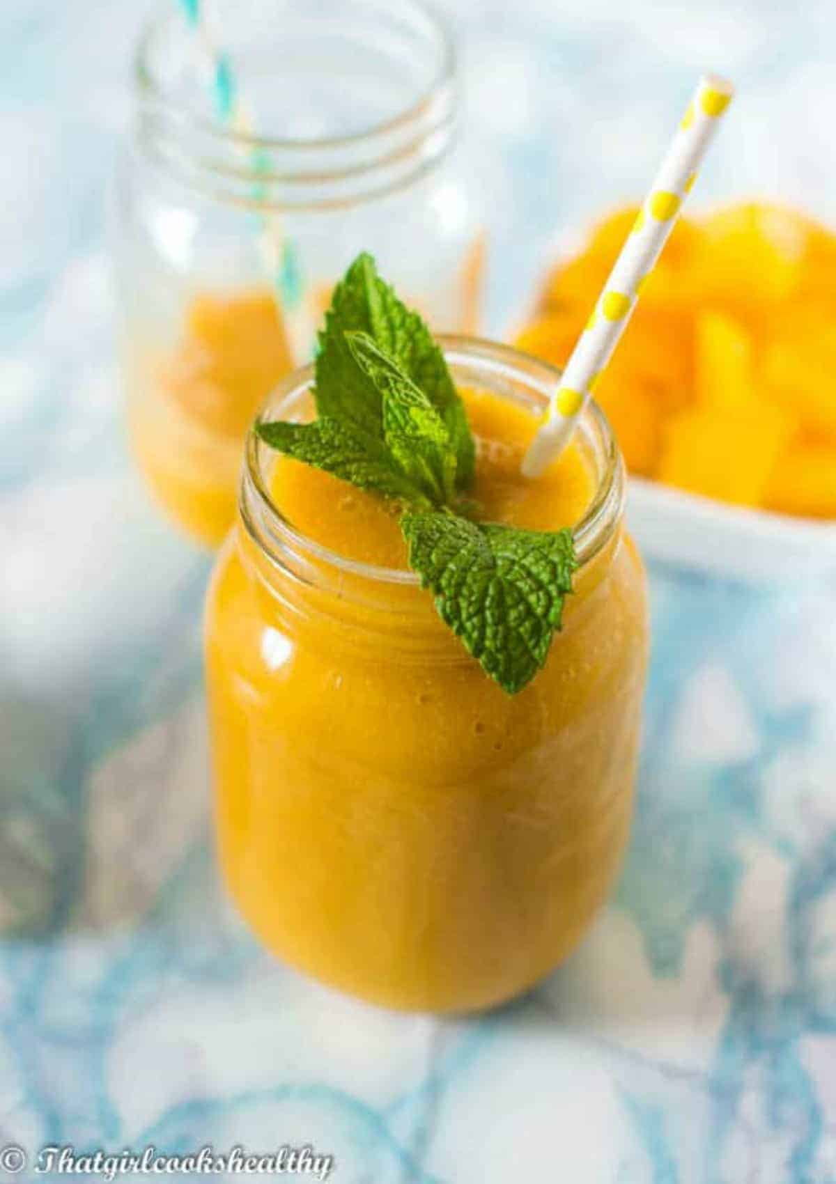 smoothie with a mint leaf and straw