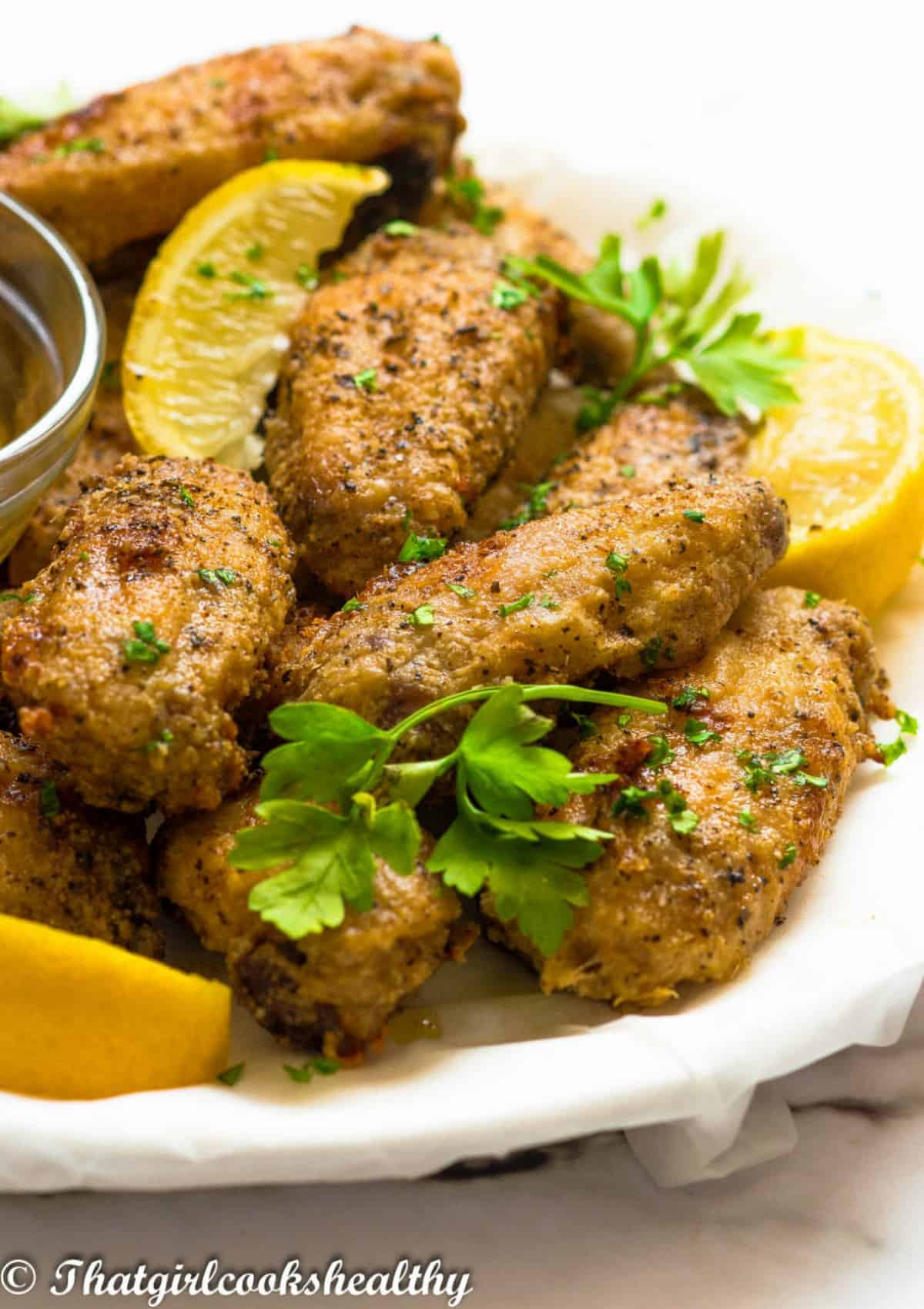 chicken wings with lemon wedges