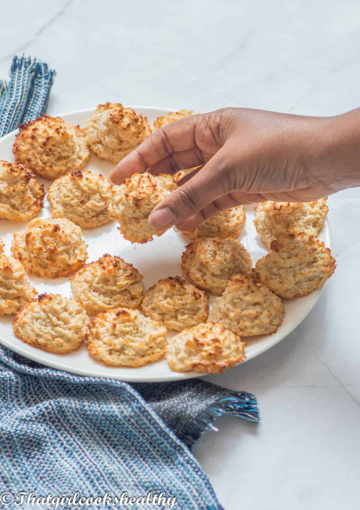 Hands picking up the macaroons