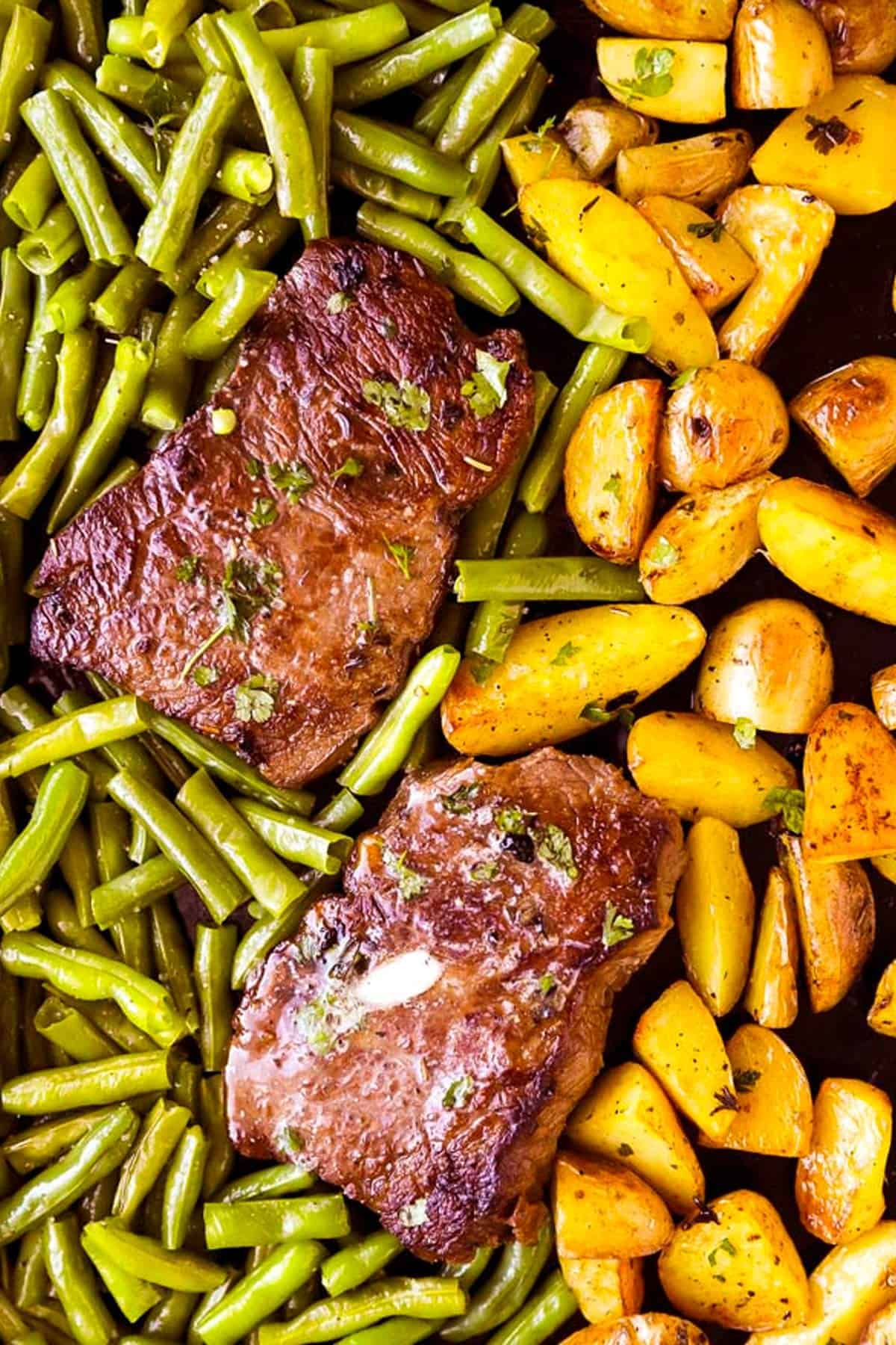 sheet pan with steaks, green beans and potatoes