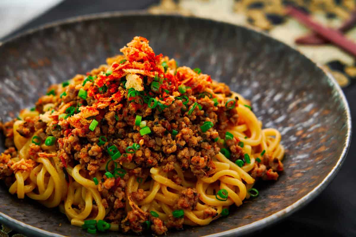 These easy spicy sesame ramen noodles are topped with an umami-bomb ground meat stir-fry.
