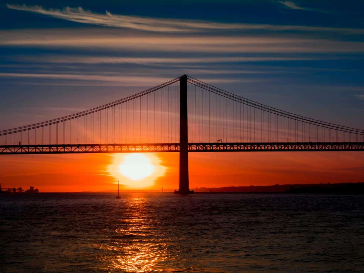 Fabulous sunset in all the colours of the rainbow under the Ponte de 25 de Abril in Lisbon.