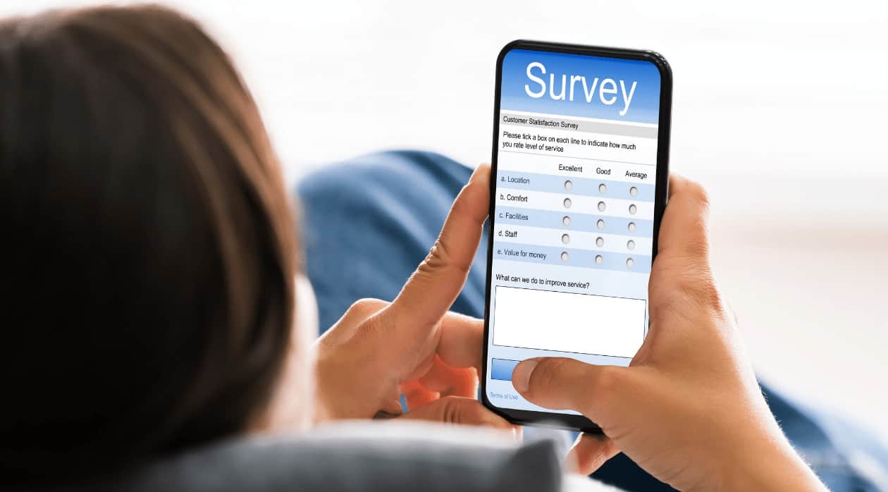 Person holding survey on a mobile device