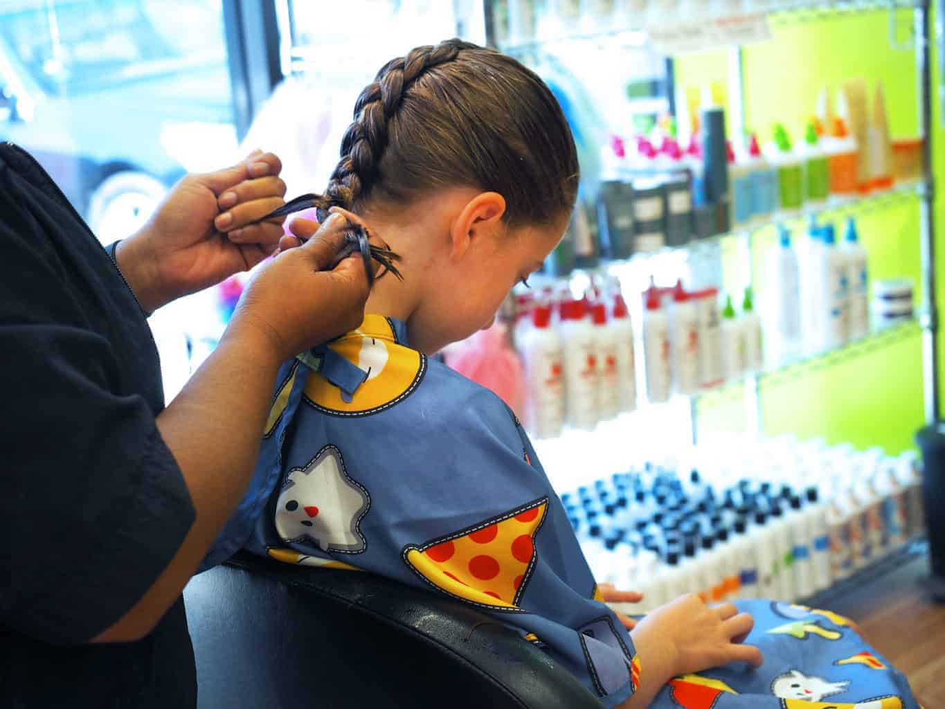 Little girl getting her hair braided 