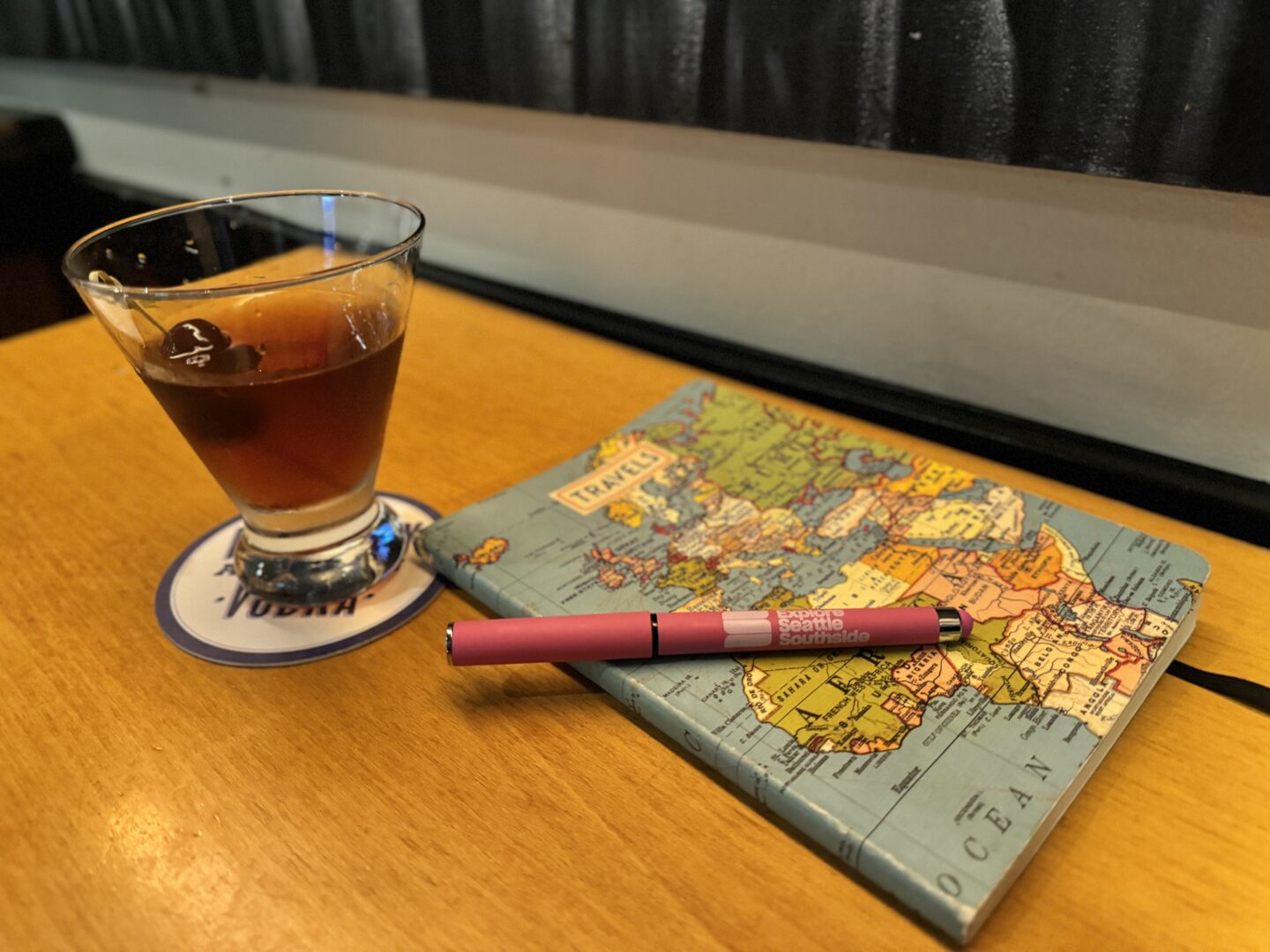 Solo travel with a Manhattan and Travel journal