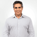 A man wearing a light gray shirt.