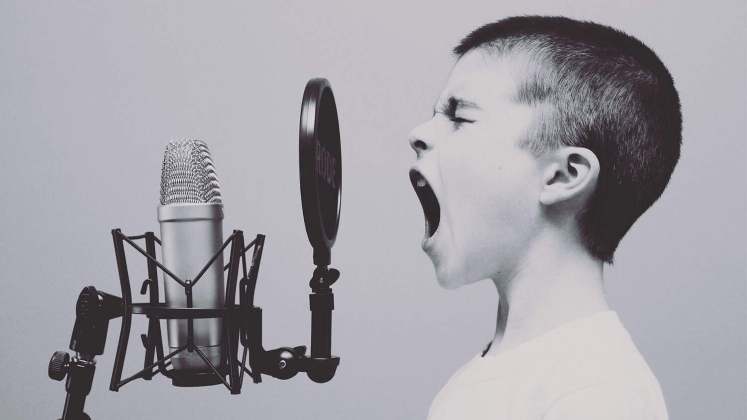 child yelling into microphone