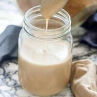 milk dripping from teaspoon