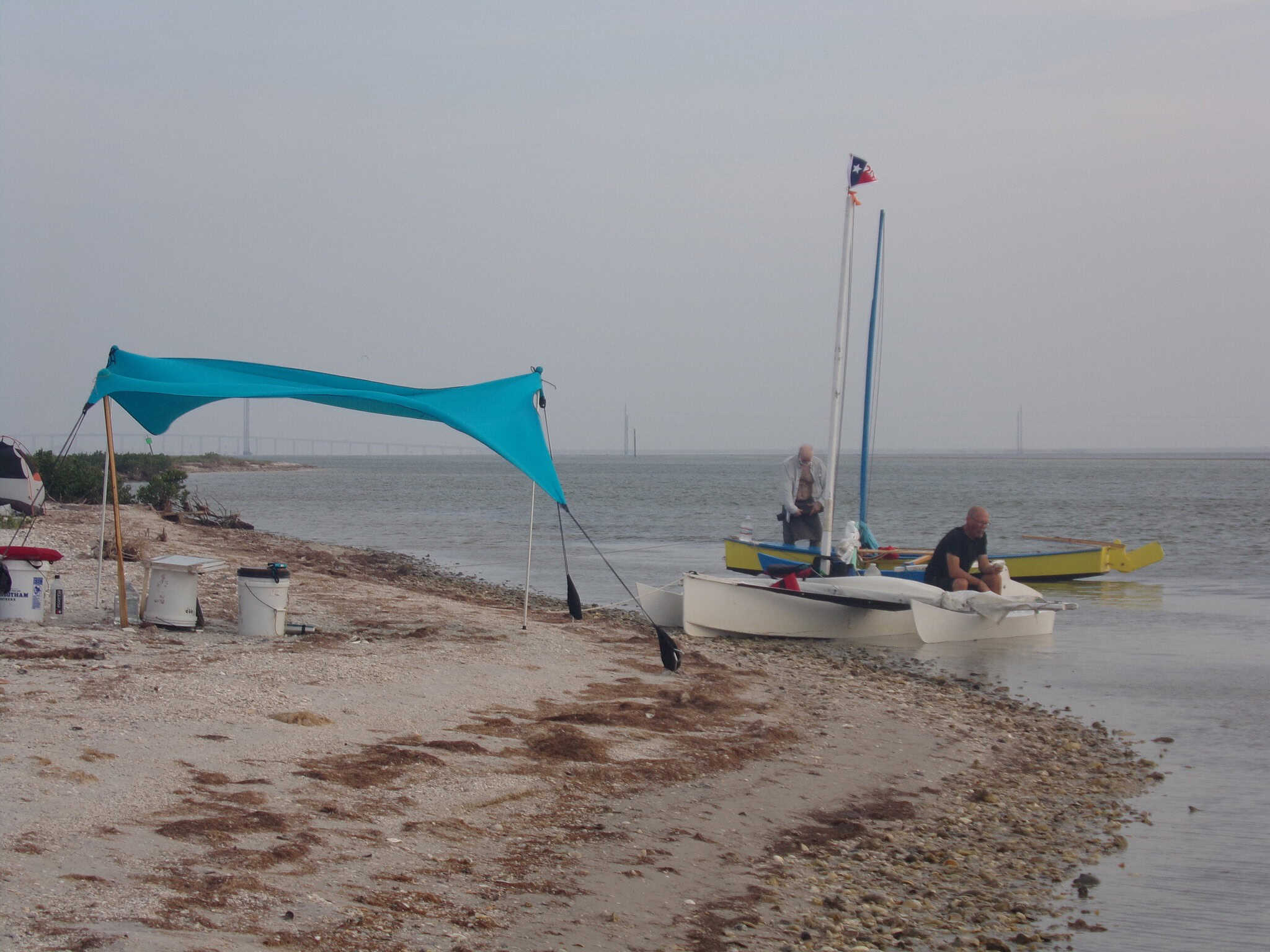 Two outrigger canoes with Really Simple sails finish Texas 200 mile on race - boat on beach