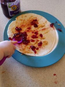 Picture of toddler spreading jelly