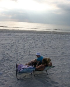 family on beach, enjoying madeira beach, madeira beach florida, florida, money saving travel tips