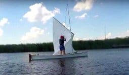 Viola 14 sailing canoe hoisting sail on the water super stable stability
