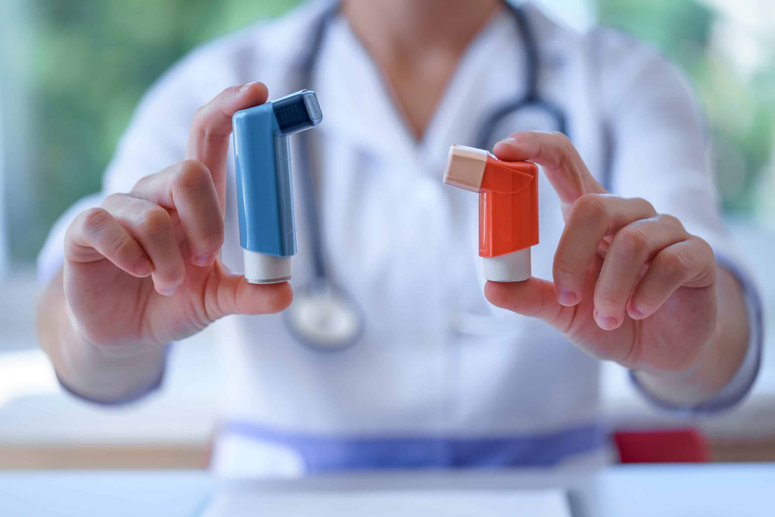 Asthma inhalers in doctor hands for asthmatic patient during medical consultation and examination. Healthcare