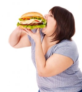 Woman eating hamburger.