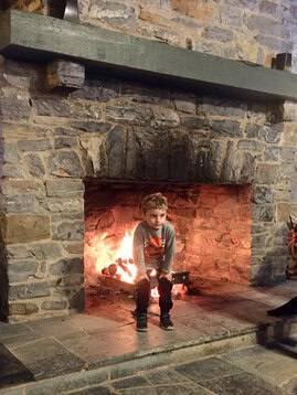 Caden Standing by the fire