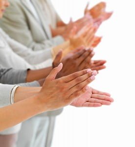 Closeup of business people clapping hands