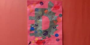 Picture of a preschooler's D is for dinosaur craft made from duct tape and dot markers
