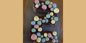 Picture of a 2nd birthday cake covered in colorful Oreo balls