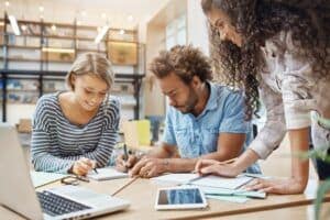 close-up-young-group-startapers-sitting-library-making-research-about-future-tem-project-looking-through-graphics-laptop-writing-new-ideas-business-teamwork-concept_176420-8310