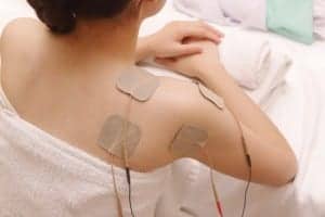 Asian woman is doing massage of electrical -stimulation ( TENs )