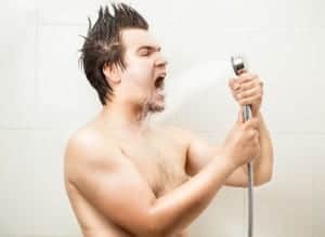 Portrait of funny man singing at shower