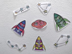 Picture of space themed sticker charts completed with stickers