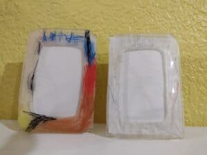Shrinky Dink Father's Day picture frames made by a preschooler and a toddler
