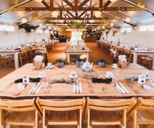 Wedding reception layout with long banquet tables and a separate top table