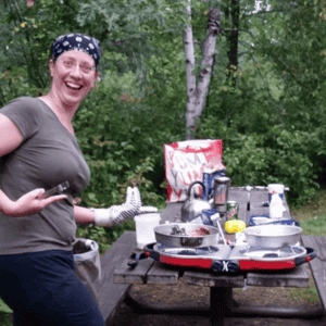 Woman using Coleman fold n go stove