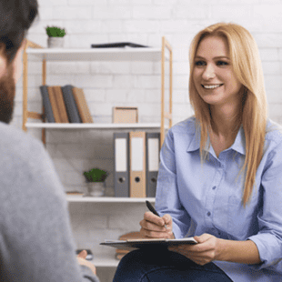 A Certified Nutrition Specialist (CNS) sits with a client