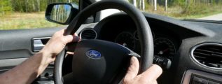 Two hands on the steering wheel