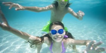 Tweens play in the water on grand bahama island