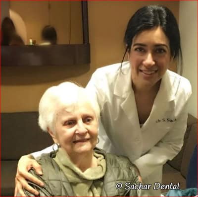 Dr Sachar with patient at Sachar Dental Picture of NYC Dentist Dr. Sandip Sachar with a patient