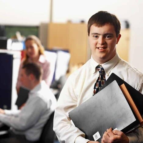 portrait of a man with down syndrome working in an office