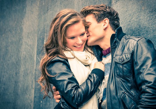 a guy kissing a girl