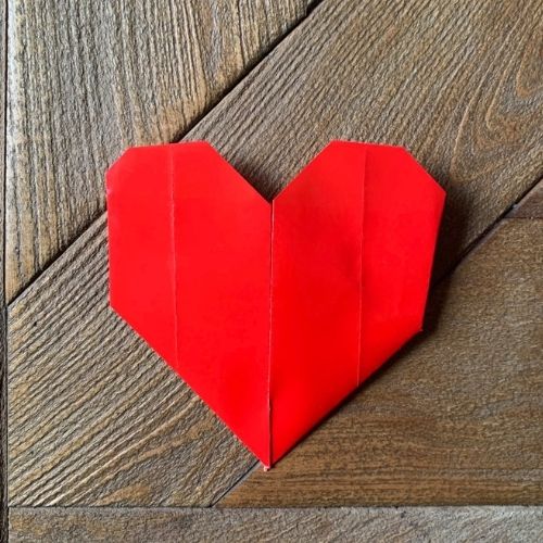 finished origami heart on wood table