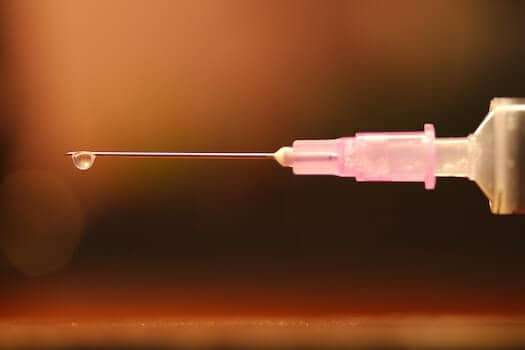 Close Up of Needle with Single Drop of Liquid Substance on the End