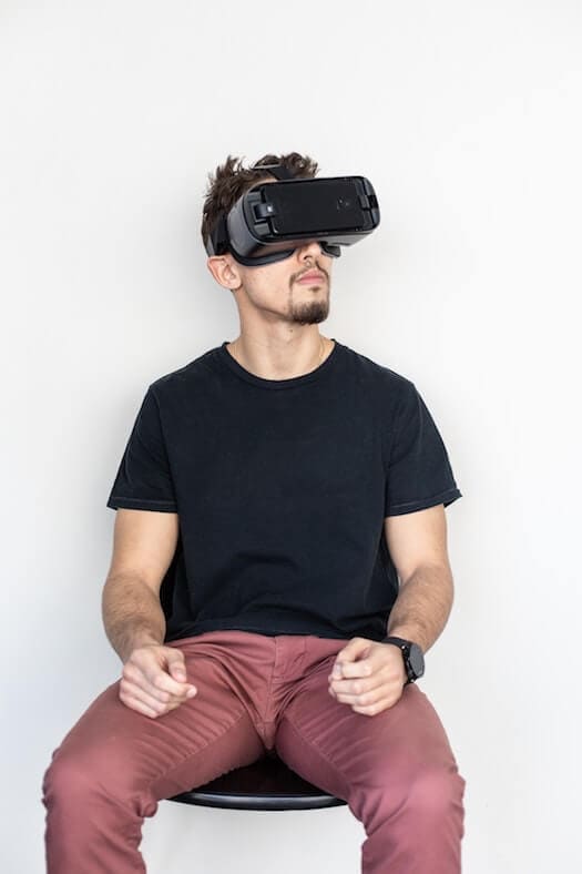 Man Sitting While Looking Into Virtual Reality Headset