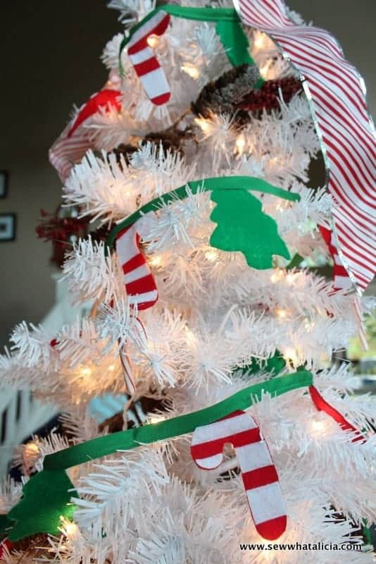 white christmas tree with candy cane and tree garland