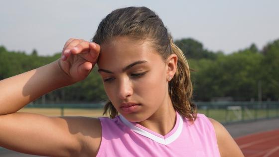 exhausted girl on track in summer