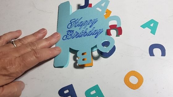 Curved text card made in Canvas Workspace nearly completed showing additional colored letters